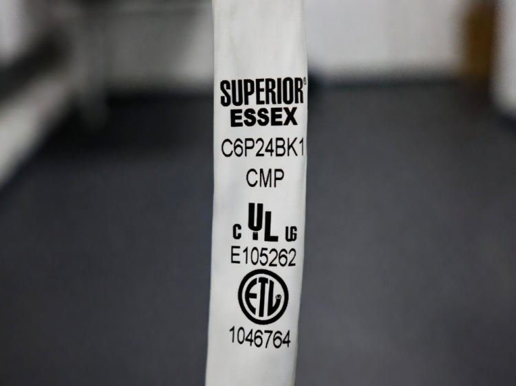 Cat6 plenum cable jacket markings showing manufacturer identification, CMP designation, and UL ETL third-party listing marks for building inspectors Cat6 plenum cable jacket markings showing manufacturer identification, CMP designation, and UL ETL third-party listing marks for building inspectors